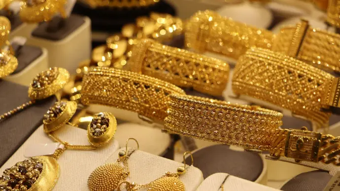 a bunch of gold jewelry on display in a store